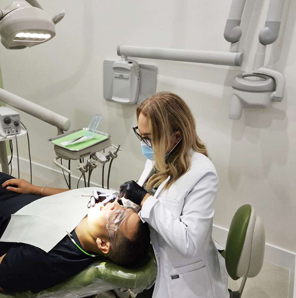 Dentist providing professional dental services at Elite Dental Touch clinic