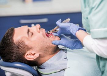 Tooth Extraction 5 cropped view of female dentist working with patient