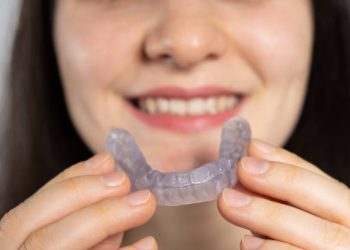 Nightguards / Mouthguards 7 A woman holds dental mouthguard, splint for the treatment of dysfunction of the temporomandibular joints, bruxism, malocclusion, to relax the muscles of the jaw