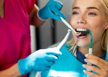 Teeth Cleaning 4 Dentist examining patient's teeth using dental tools during a checkup at a dental clinic