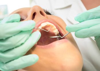 Teeth Cleaning 1 Woman having teeth examined at dentists