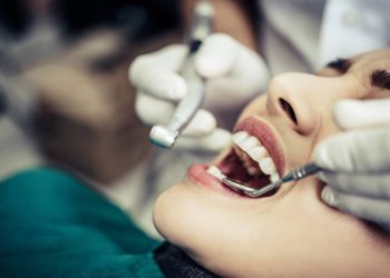 Teeth Cleaning 3 The dentist examines the patient's teeth.