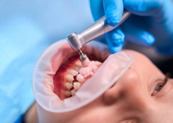 Teeth Cleaning 5 Dentist removes plaque from a teenage girl, the doctor uses a special attachment